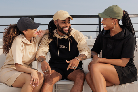KIN models wearing satin lined, waterproof dad hats in black, olive green, and tan