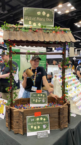 booth worker guarding the Well of Many Dice