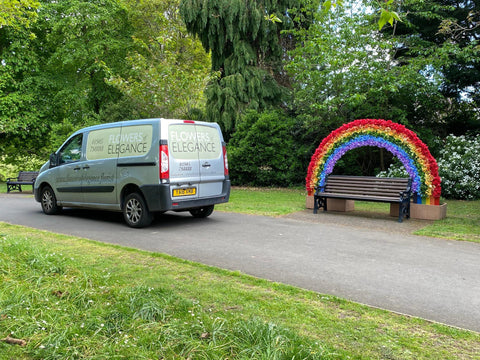 Floral rainbow across a bench 