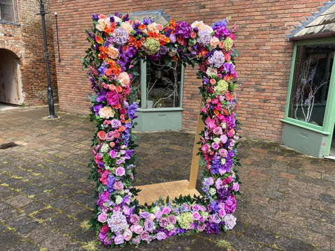 Human sized floral photoframe in cerise, lilac and peach tones 