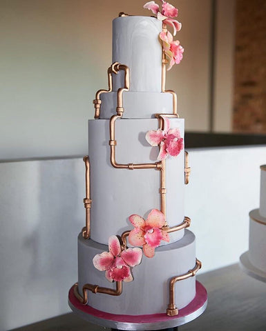 MY BAKER Top 25 Inspirational Baker Awards - @alliancebakery - A multi tiered cake with flowers and a steam punkesque pipe climbing the towering cake