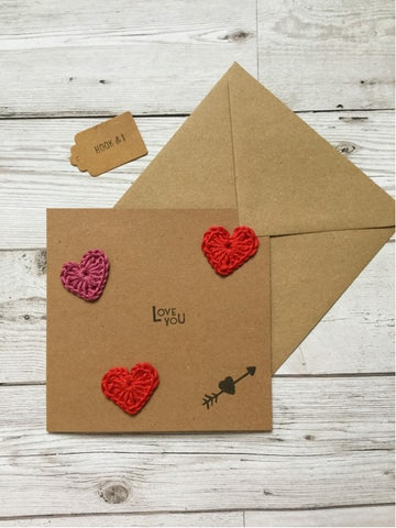 MY BAKER's Valentine's Day Gift Giveaway includes a cute brown paper card with red crochet love hearts floating on top