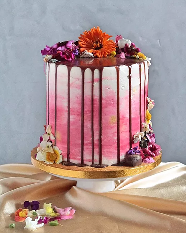 Watercolour pink drip cake with flowers