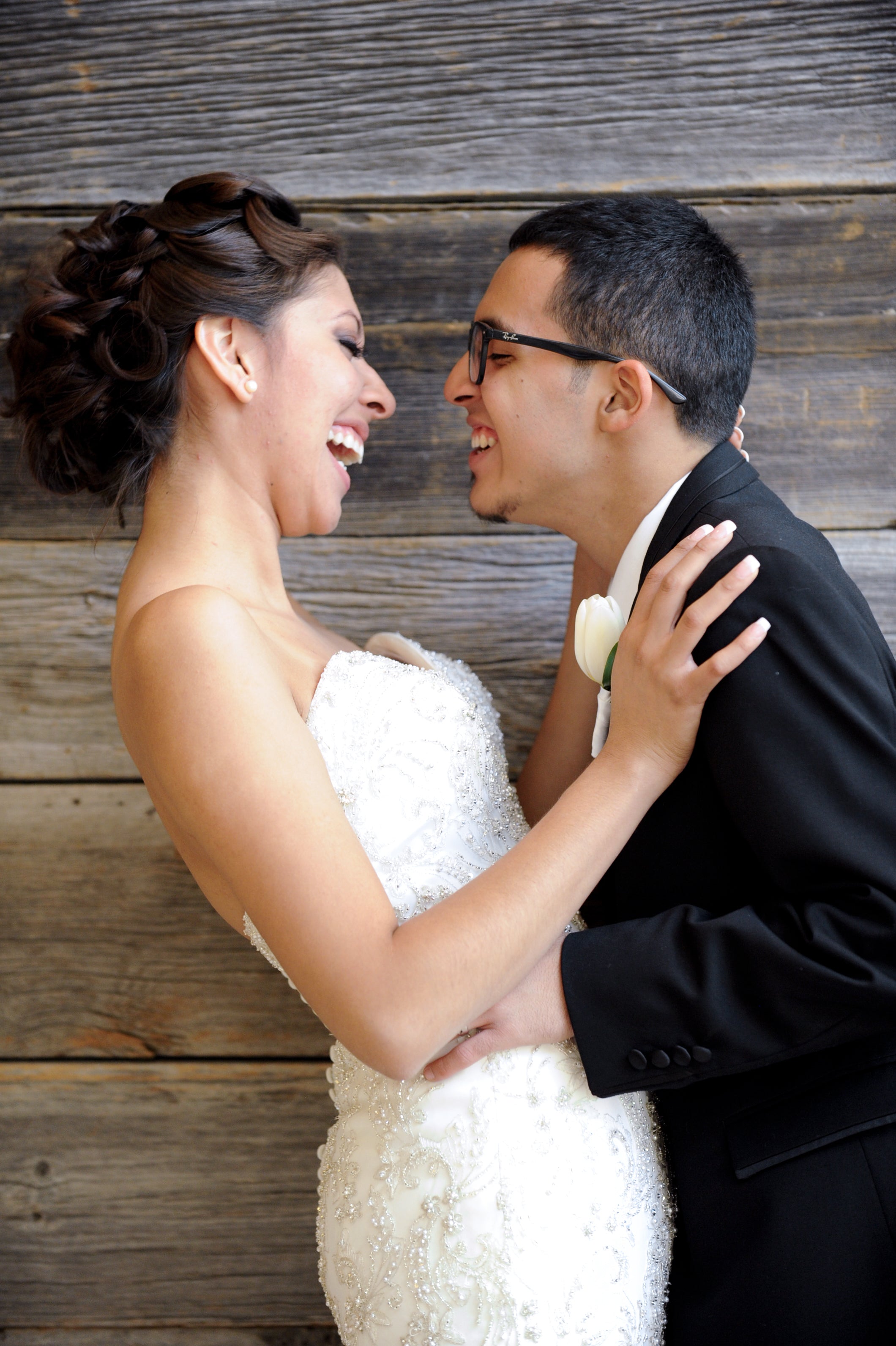 Newlyweds holding each other and laughing at Aria Hotel & Casino in Las Vegas, NV.