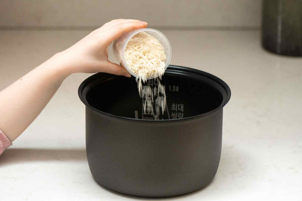 Step by step guide to using a rice cooker - tip your rice into the cooker
