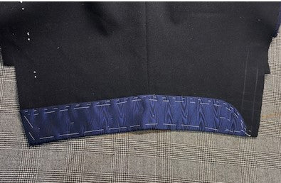 A Navy Moire Silk turnback cuff basted on to the sleeve of a dinner jacket. 