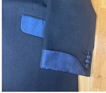 Suit jacket completed showing detail of silk pocket flaps and silk turn back cuffs 