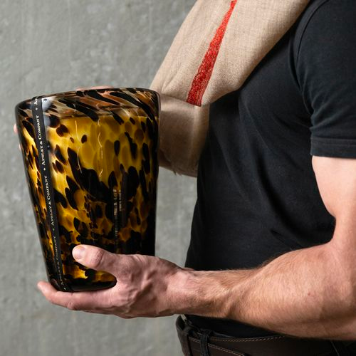 Muscle man holding massive tiger pattern candle