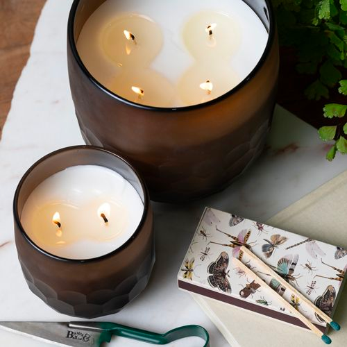 large and small candles on desk