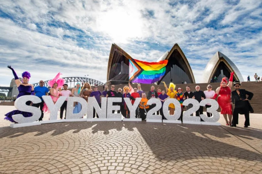 Sydney Opera House with rainbow flag and sydney 2023 lettering