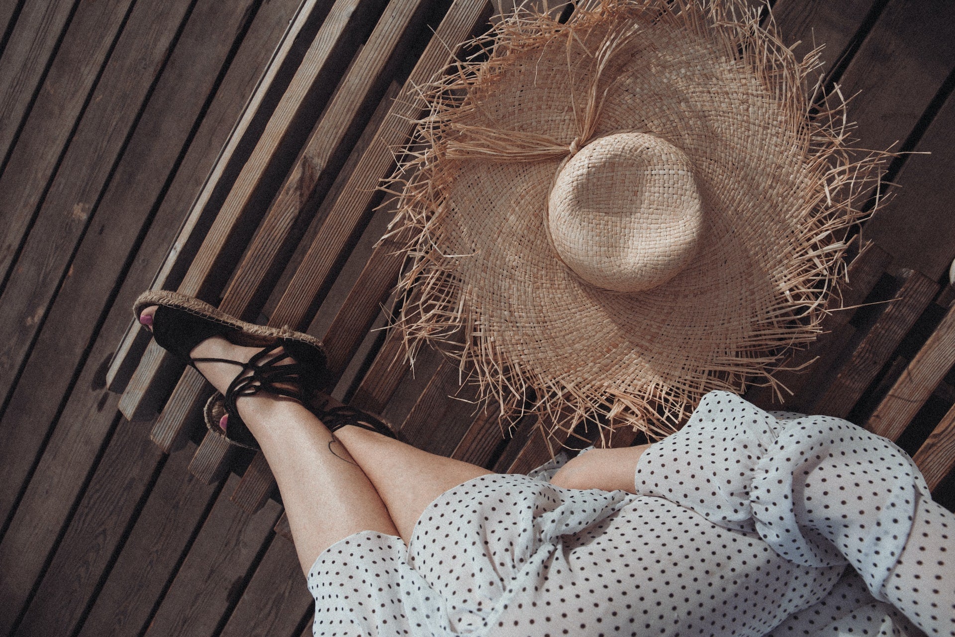 sun hat on the floor, feet up, resting