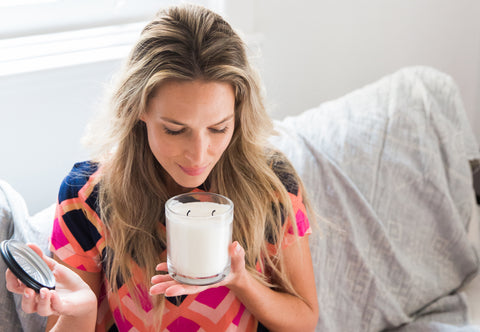 woman smelling candle