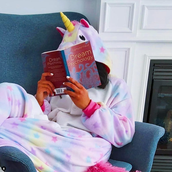 Pastel Unicorn Kigurumi reading a book