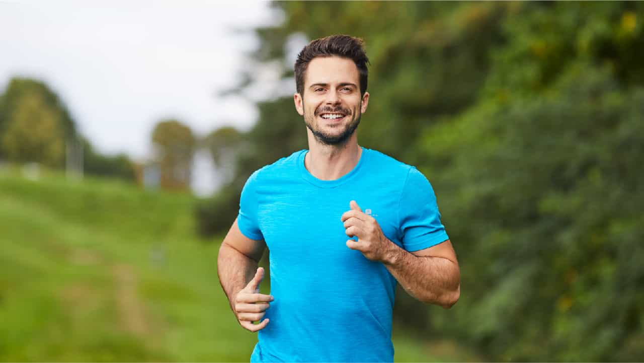 Man in  gym gear running outdoors