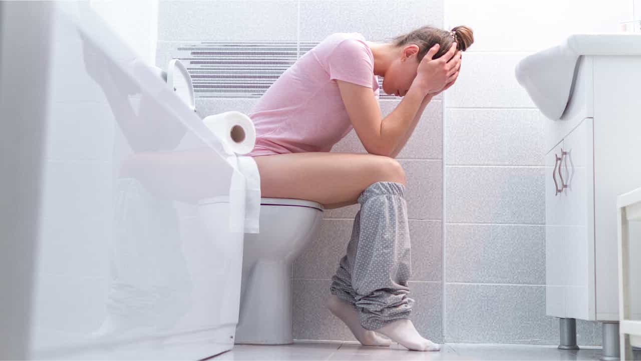 Woman sitting on the toilet