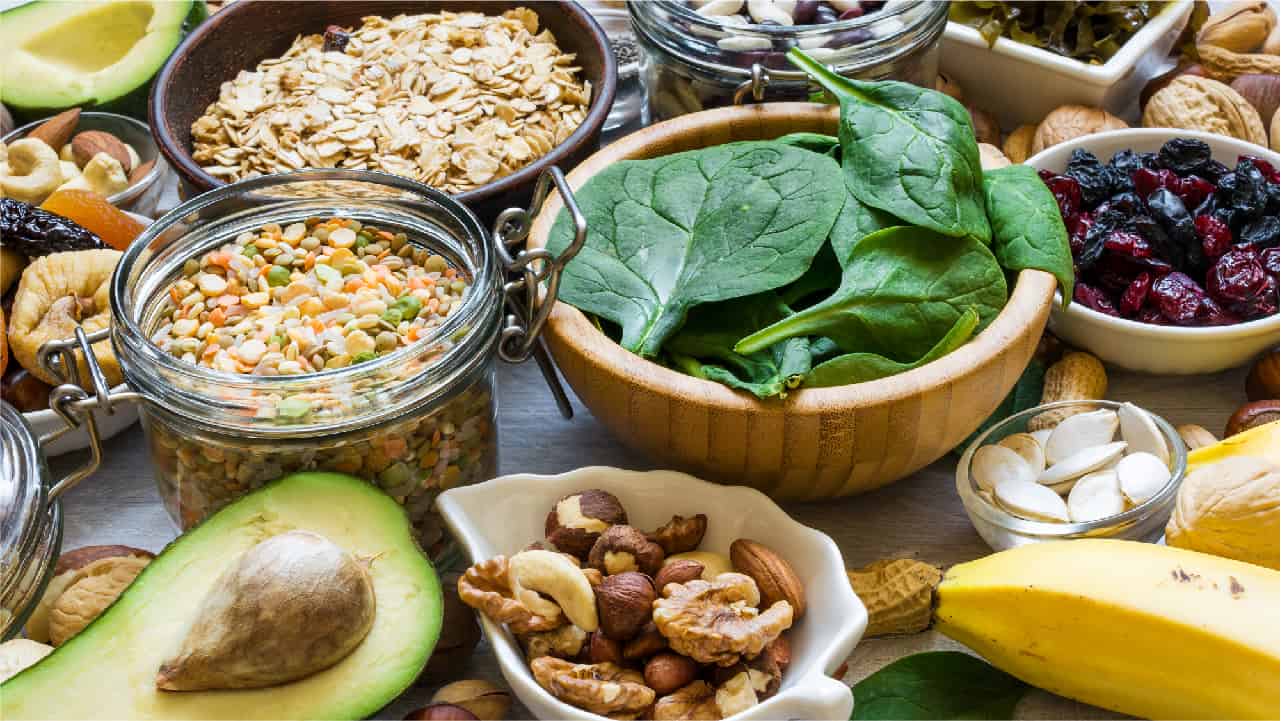Avocado, pulses, almonds, nuts and leafy greens to show the many foods that contain magnesium
