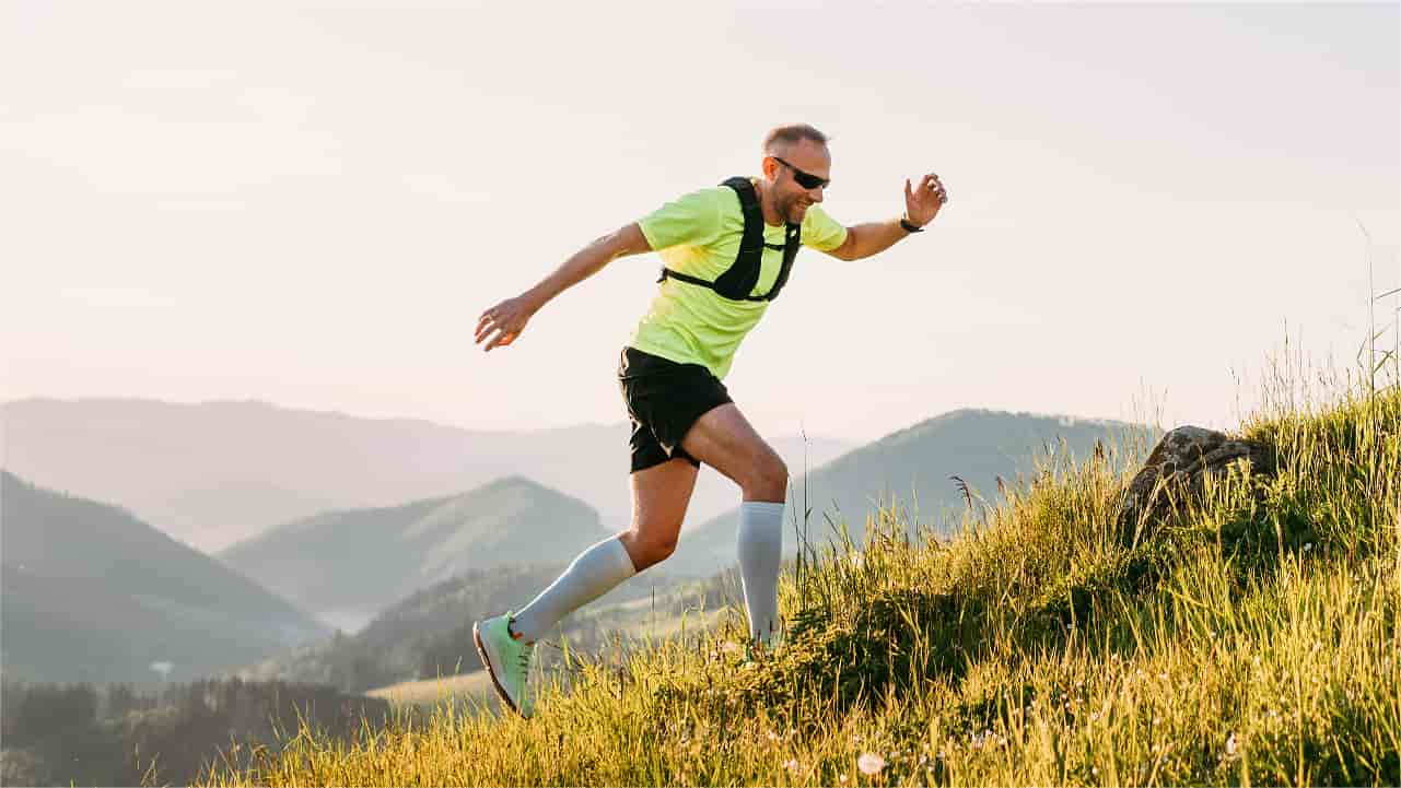 Man with running harness on an intensive trail run