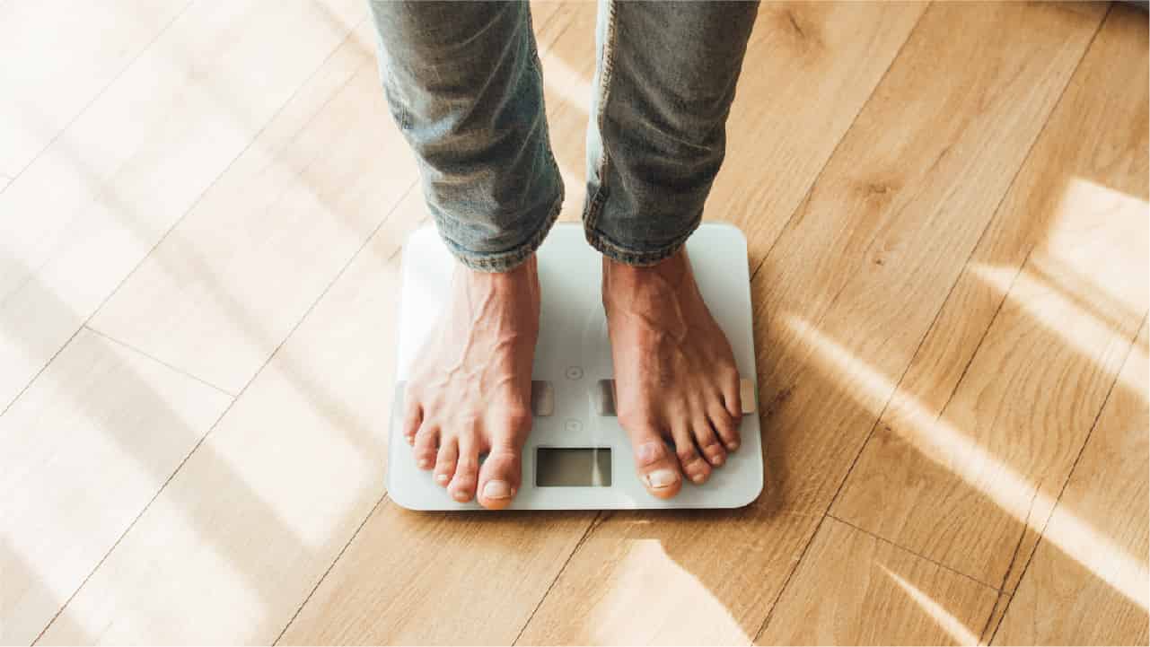 Man standing on body weight scales