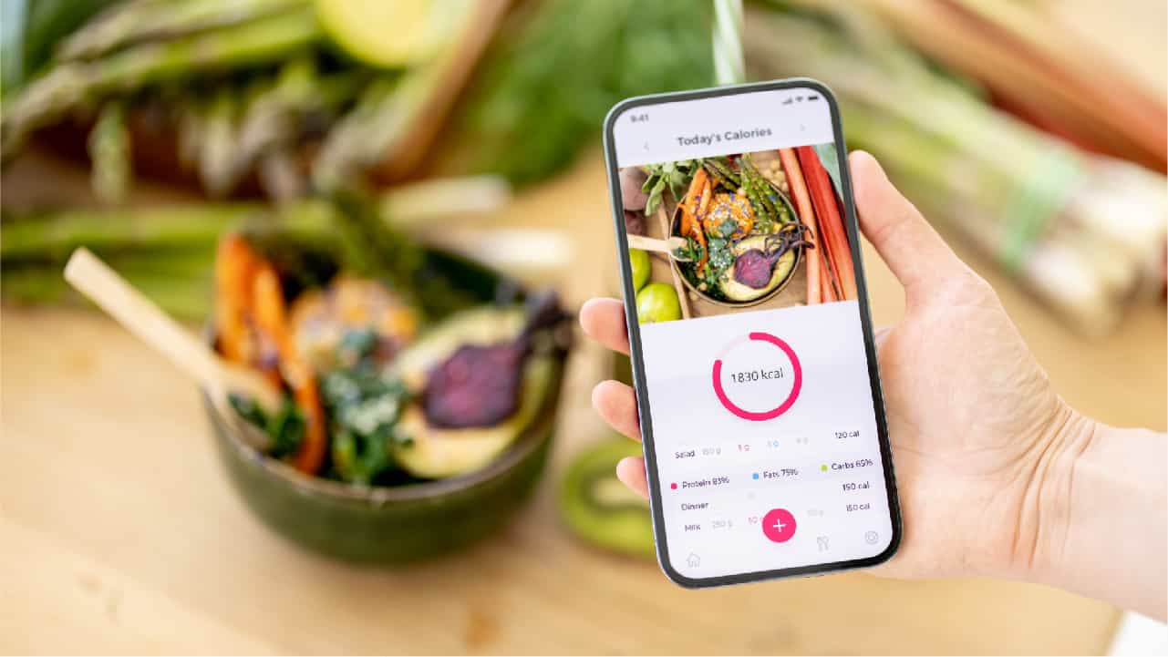 Phone app for calorie tracking with 'health food' in the background