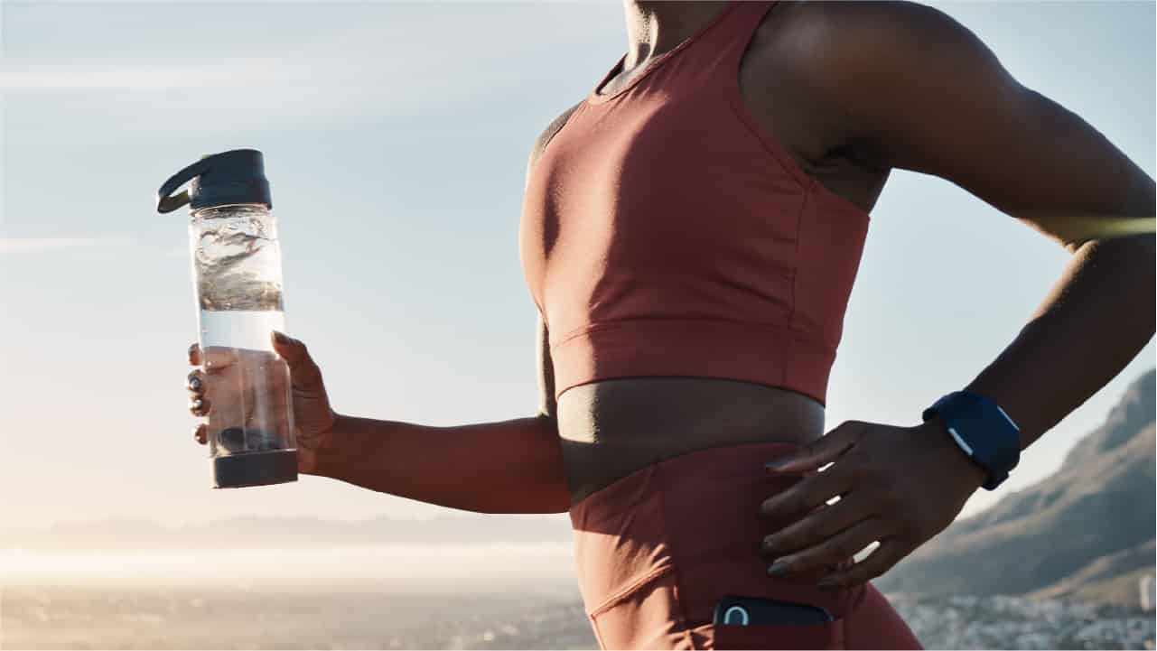 Woman running and holding a bottle of water