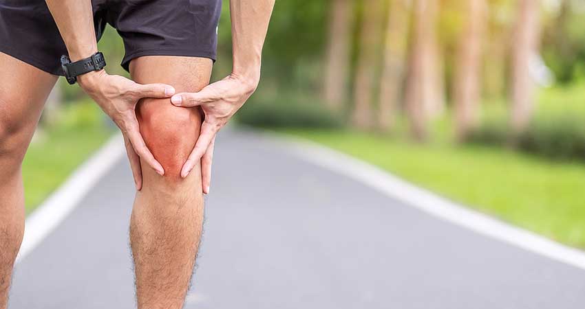 Man experiencing joint pain when running not protecting his joints correcting
