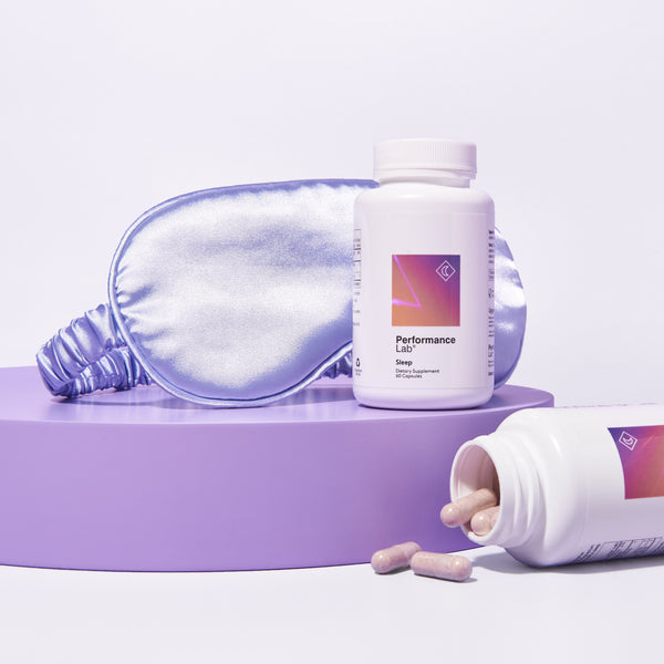 Image shows 2 bottles of Performance Lab sleep supplement against a lilac background next to a satin sleep mask.