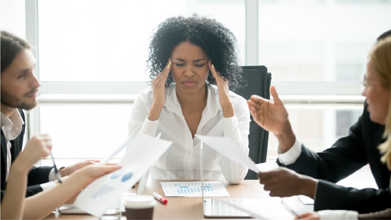 woman looking stressed at work, a reason for bedtime procrastination