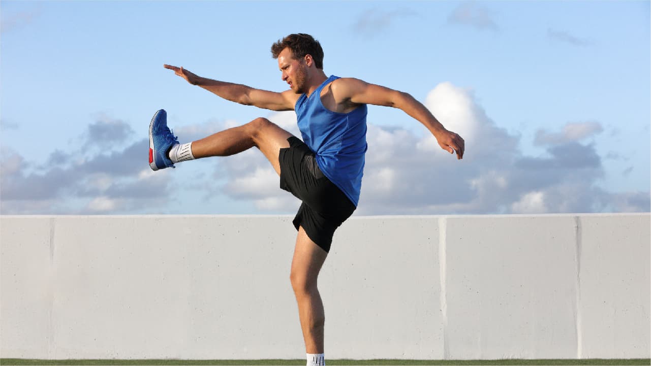 Man doing dynamic stretching outside