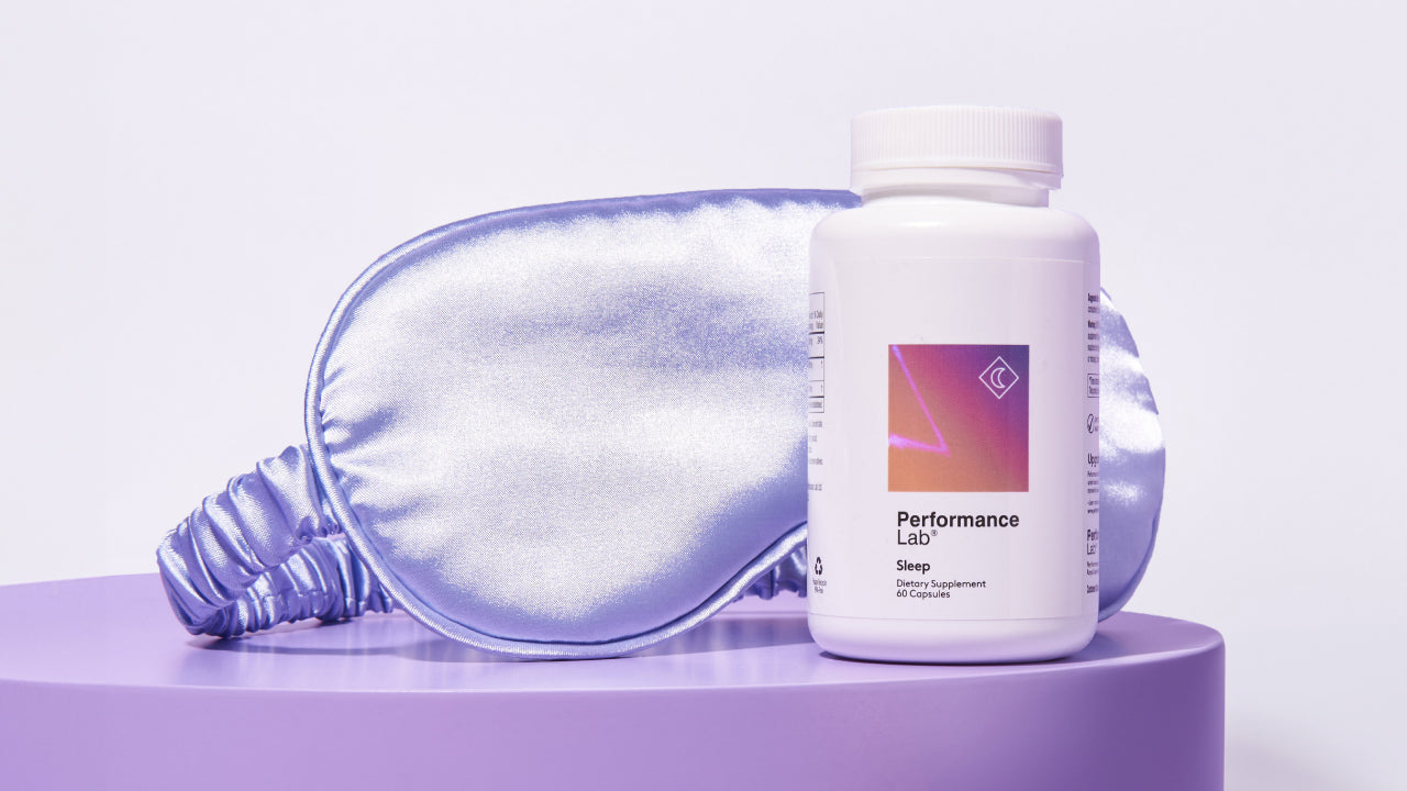 A bottle of Performance Lab Sleep supplement and a lilac silk sleep mask in the background
