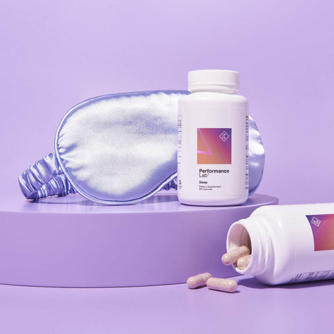Bottles of Performance Lab Sleep supplement against a lilac background with a silk sleep mask.