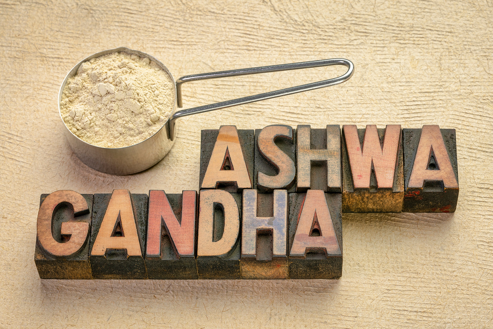 Ashwagandha as a powder and in letters on a powder background
