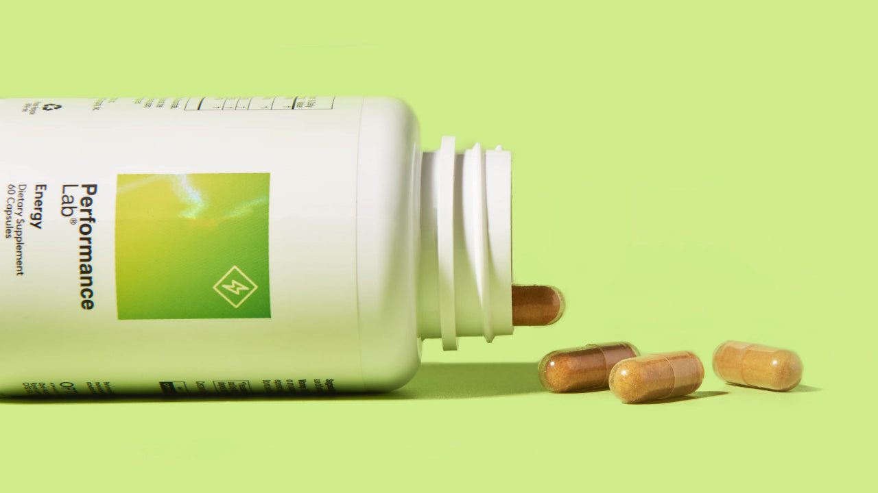 Best Dietary Supplement with CoQ10: Performance Lab Energy. Its bottle is shown open on its side with capsules spilling out.