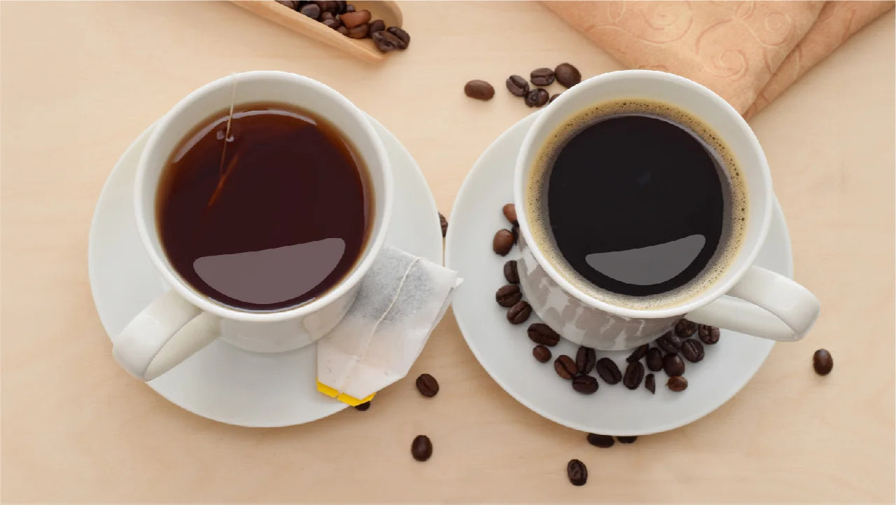 A mug of black coffee and mug of brewed tea. The coffee mug has whole coffee beans scattered on its saucer. Coffee and tea may not break a fast if they are enjoyed unadulterated.