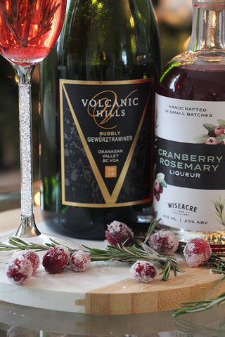 cranberry rosemary cocktail with bubbly gewurztraminer candied cranberries flocked rosemary frosted cranberry