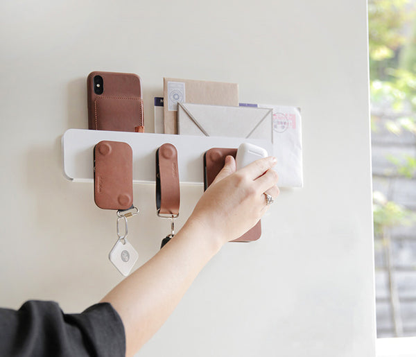ModStation on a magnetic door with modular leather accessories