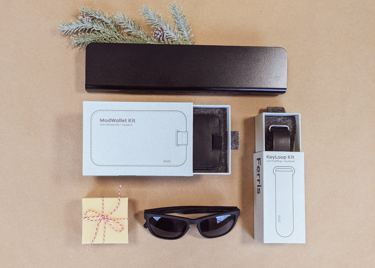 An assortment of Distil Union gear including Ferris ModStation, ModWallet Kit, KeyLoop Kit and MagLock Sunglasses