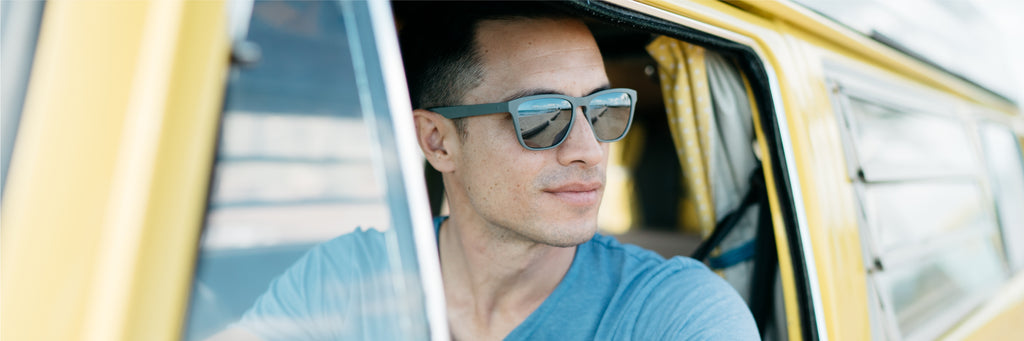 A man in a VW van wears a gray pair of MagLock Folly Sunglasses by Distil Union