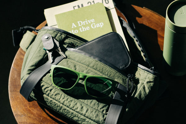 Distil Union MagLock Folly Sunglasses paired with a Craighill sling bag and Field Notes