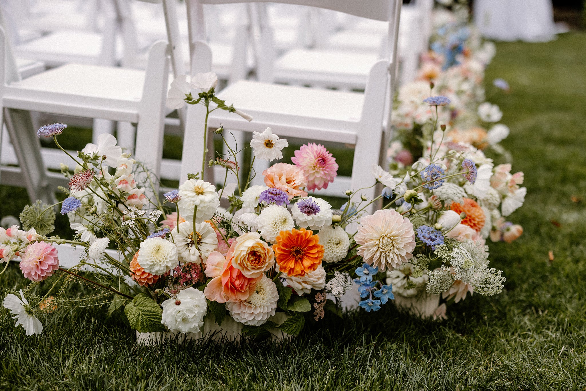 Movable aisle runner florals along the ground in English garden wedding.