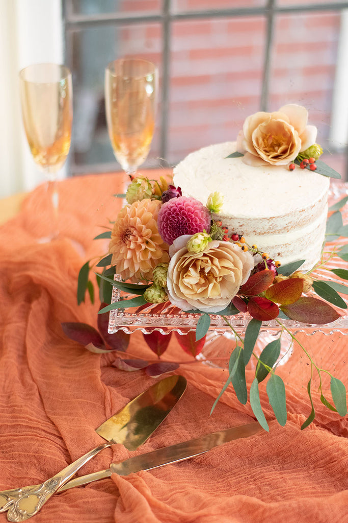 Cake with florals from Amara's Bakeshop with dishes from Cranberry Sky Heirlooms