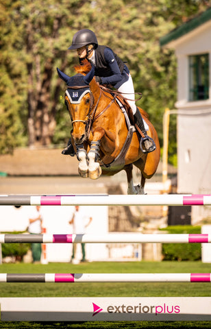 Sienna Charles jumper her horse over an oxer wearing EquiFit D-Teq Front Boots.