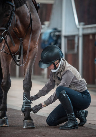 Sienna Charles tacking her horse up with EquiFit D-Teq Front Boots.