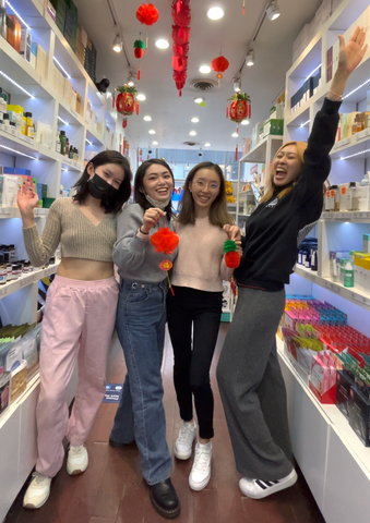 Four employees smiling at the store