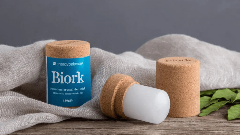 A crystal natural deodorant stick by Biork lying on a table out of its packaging