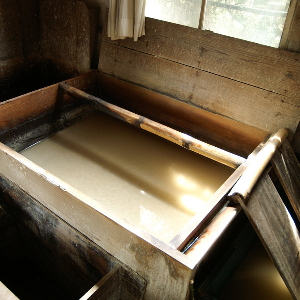 Washi bath of toroso, kozo fibres and pure ice cold water to make the best Japanese paper