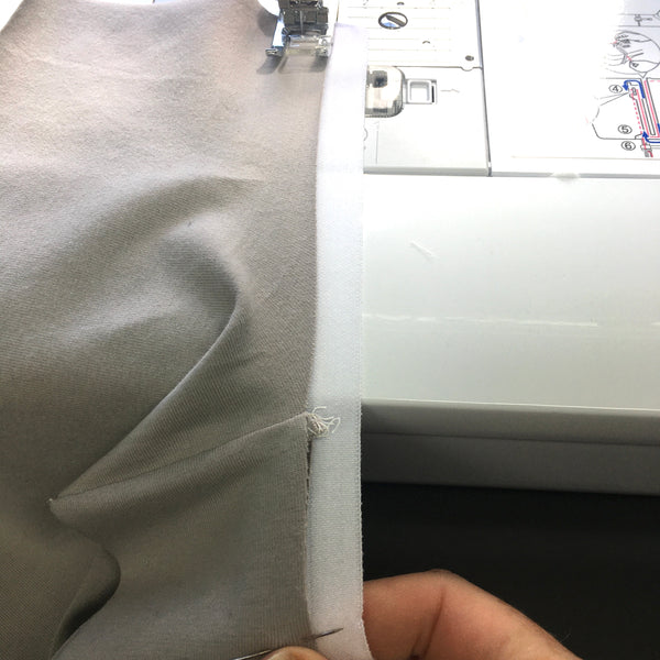 Stretching the elastic to fit the fabric