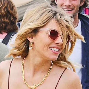 Sienna miller wearing gold jewellery at Glastonbury 2022