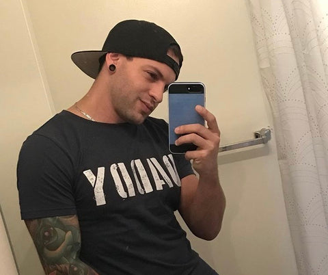 Eddie Danger taking a selfie wearing a blue DADDY T-shirt