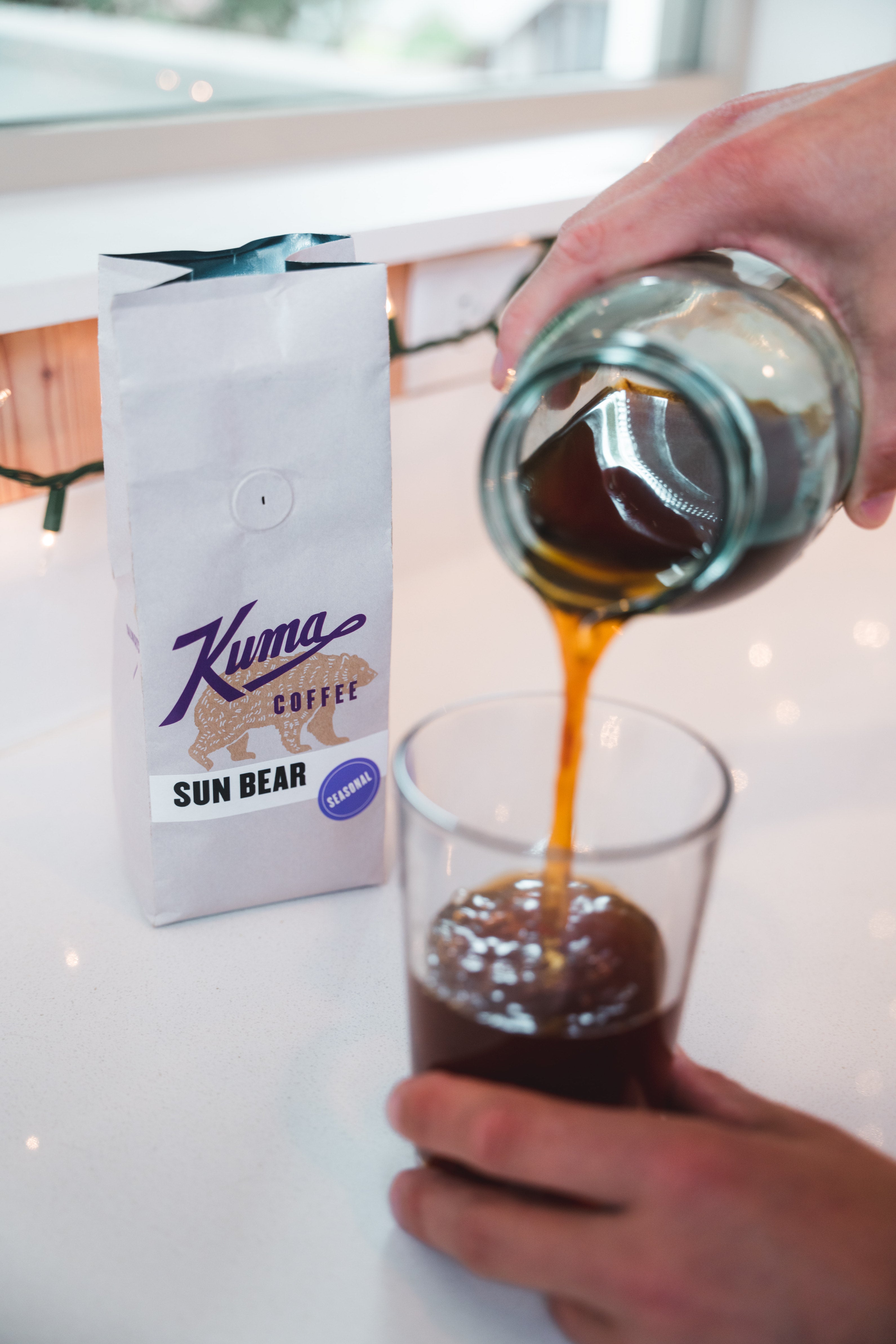 pouring finished cold brew coffee from Kuma Coffee Sun Bear iced coffee blend