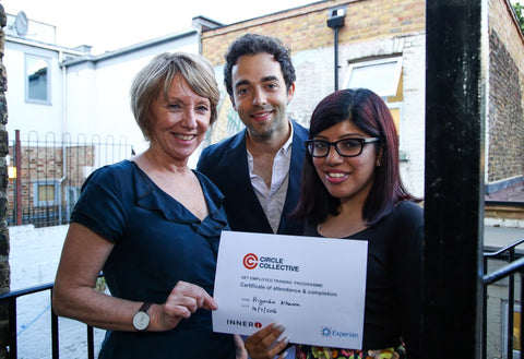 Circle Collective graduate stands with her certificate and two of Circle's corporate partners